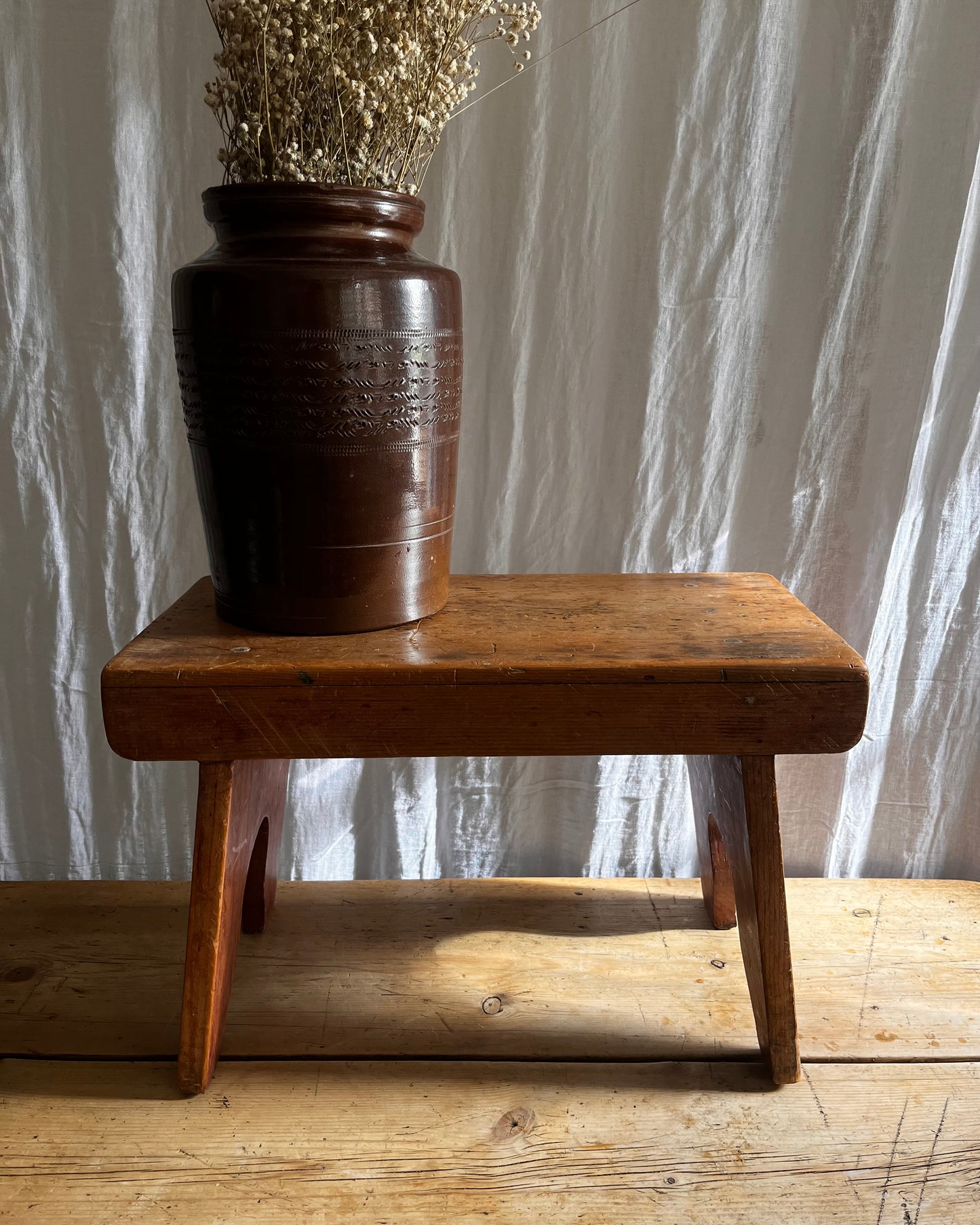Antique country farm house wooden foot stool with a vintage french ceramic kitchen storage utensil holder