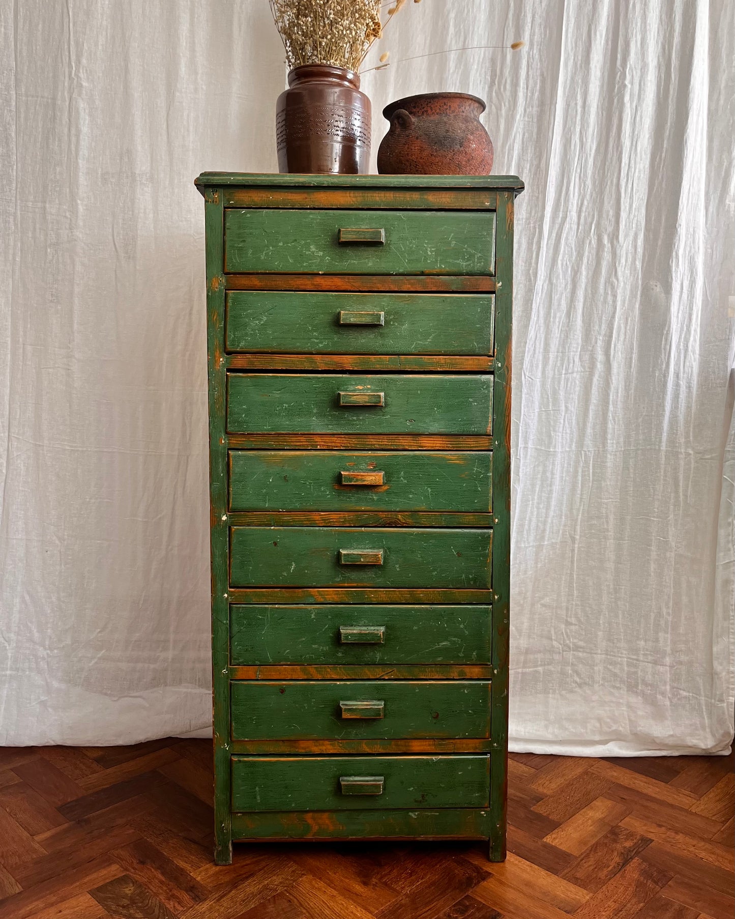 Vintage handmade 1940s green painted wooden tallboy with vintage french utensil pot and an antique stone ware cooking pot