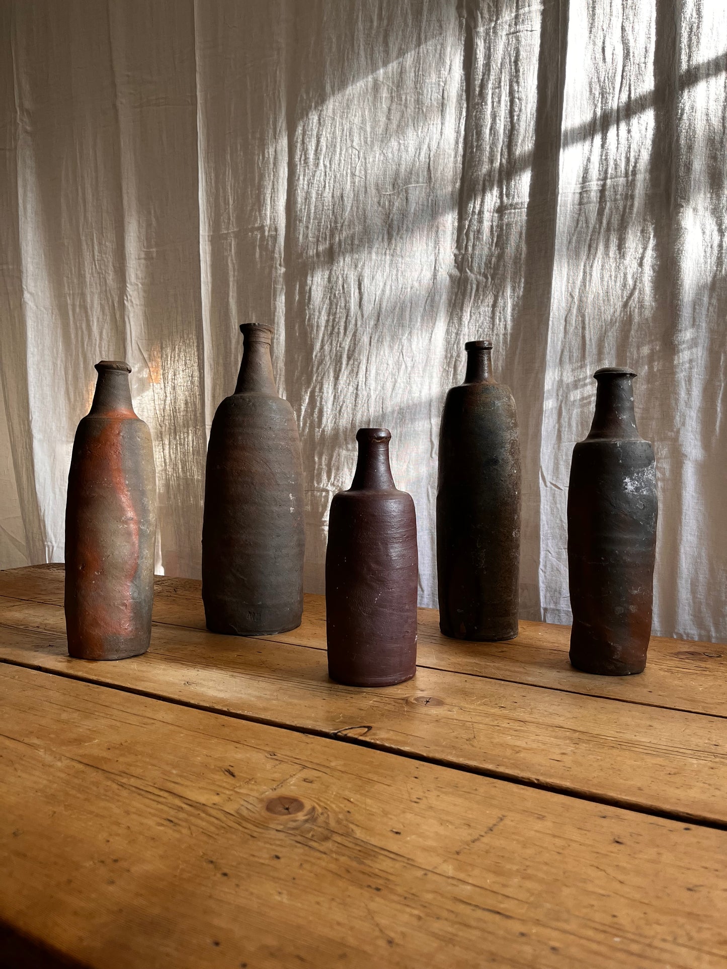 A Set Of French Clay Irregular Cider Bottles