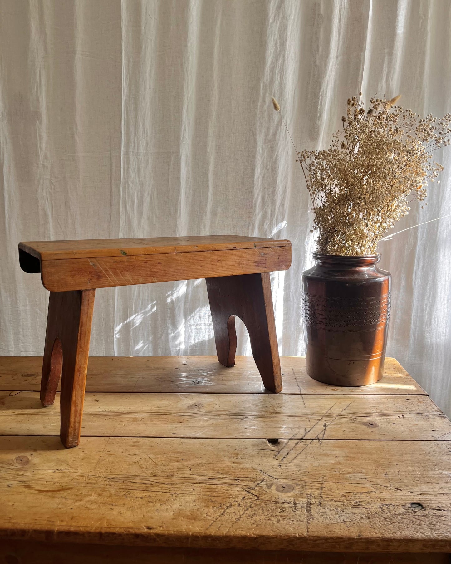 Antique country farm house wooden foot stool with a vintage french ceramic kitchen storage utensil holder