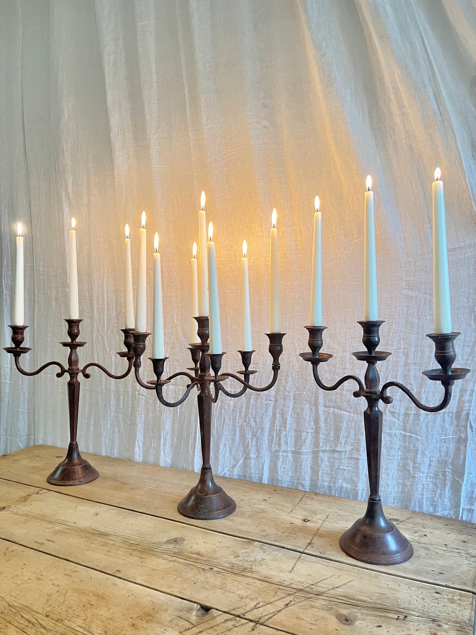 Three antique Edwardian cast metal candelabras 