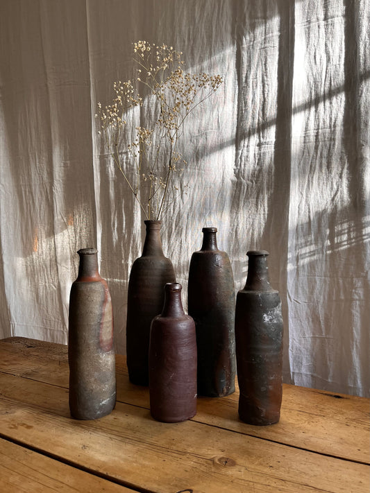 A Set Of French Clay Irregular Cider Bottles