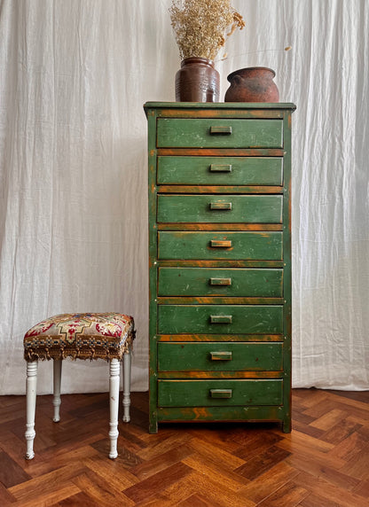 Vintage handmade 1940s green painted wooden tallboy with vintage french utensil pot, antique stone ware cooking pot, and a hand sewn antique folk art tapestry stool