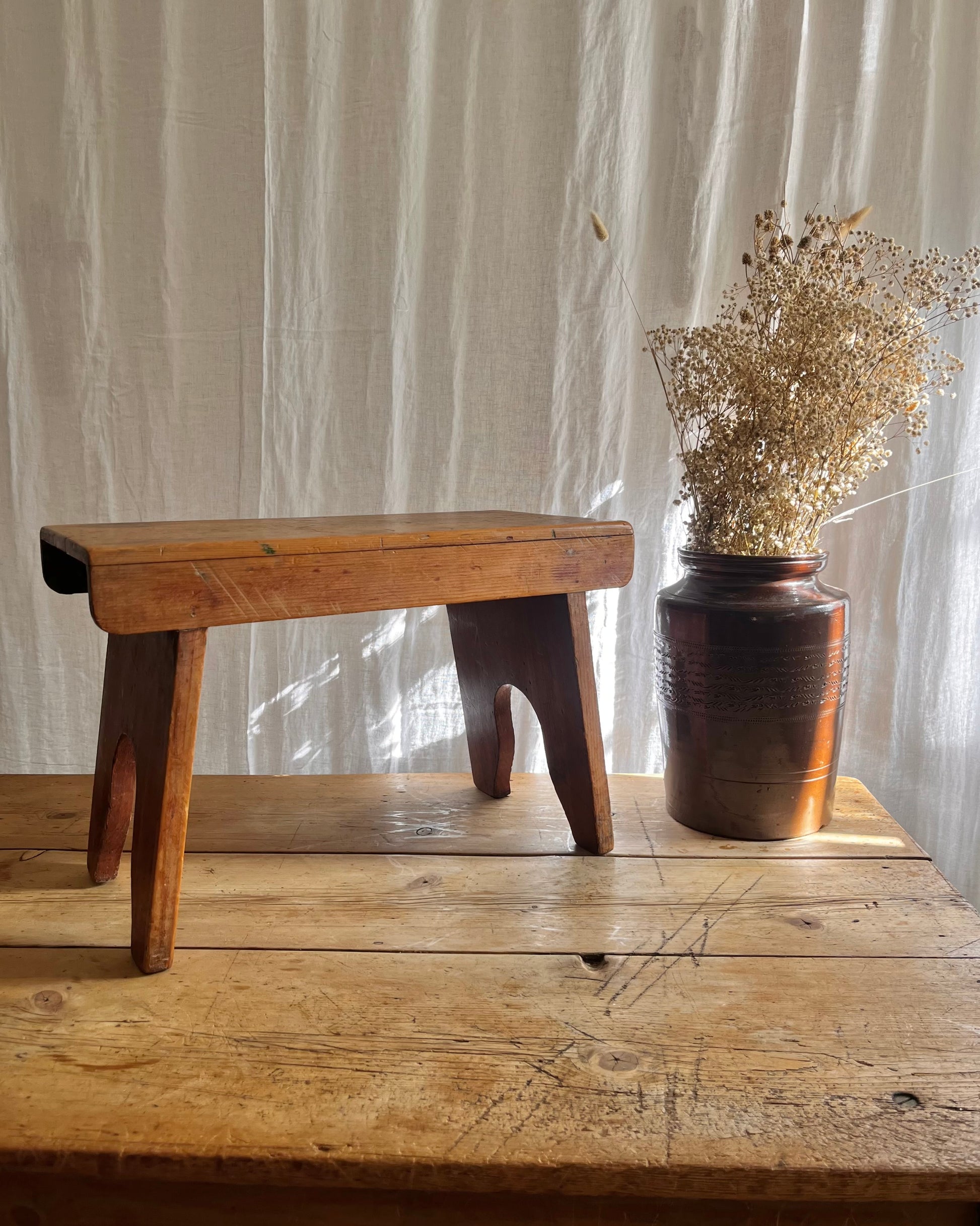Antique country farm house wooden foot stool with a vintage french ceramic kitchen storage utensil holder